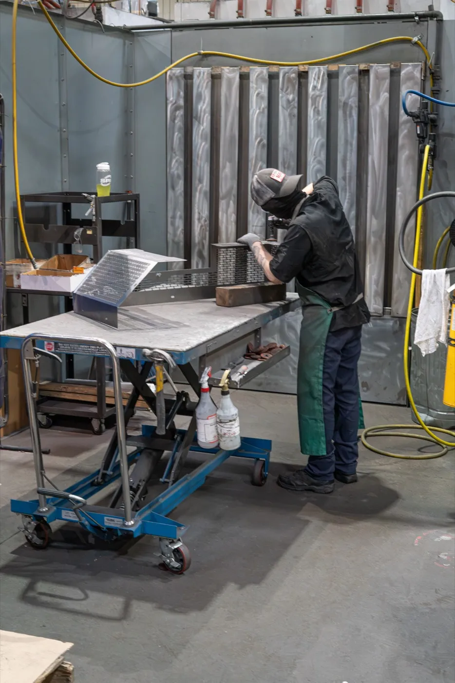 Parts moving through SPM's powder coating finishing line.