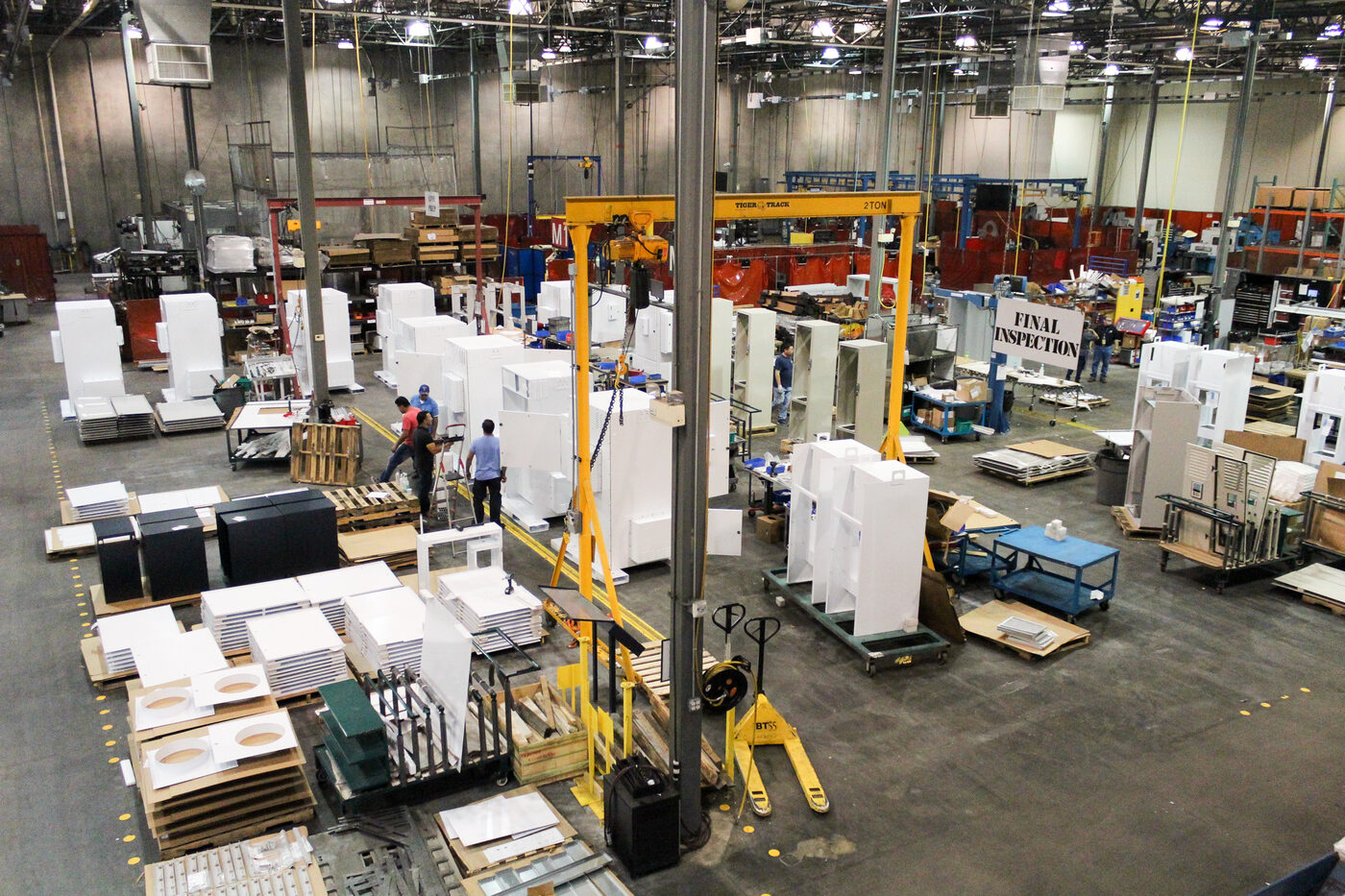 SPM electro-mechanical assembly operator populating an enclosure