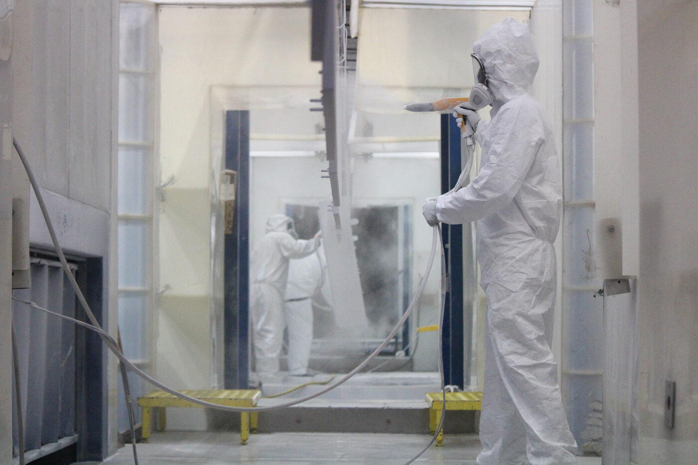 Powder-coated sheet metal components on the finishing line at SPM