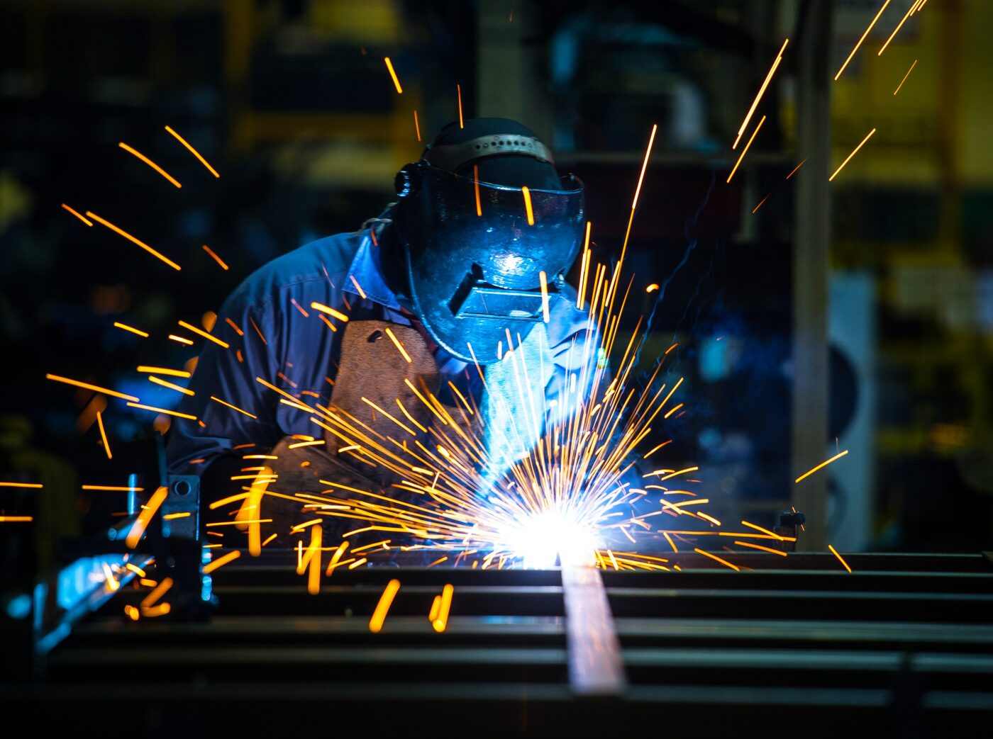 Certified SPM welder running a manual arc weld on the welding floor