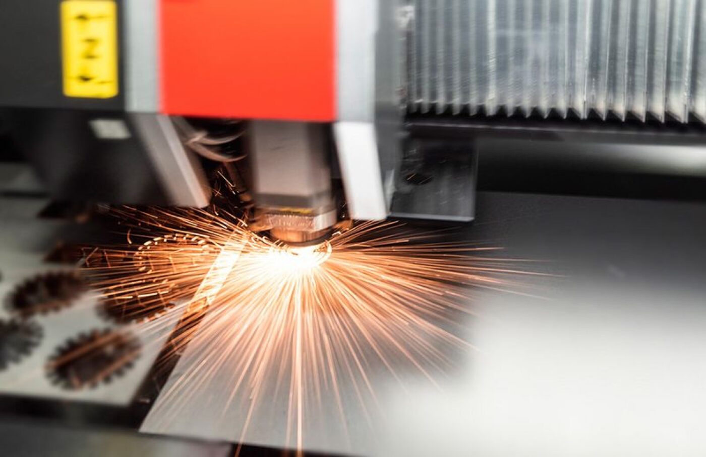 Fiber laser cutting head in operation on the SPM sheet metal fabrication floor