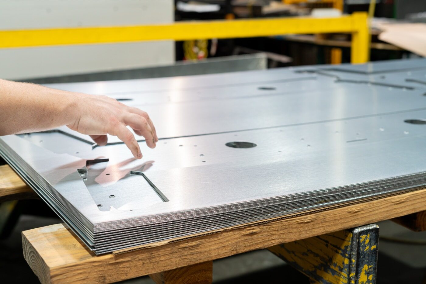 Detail of SPM punched sheet metal parts showing holes, countersinks, embossments, and louvers