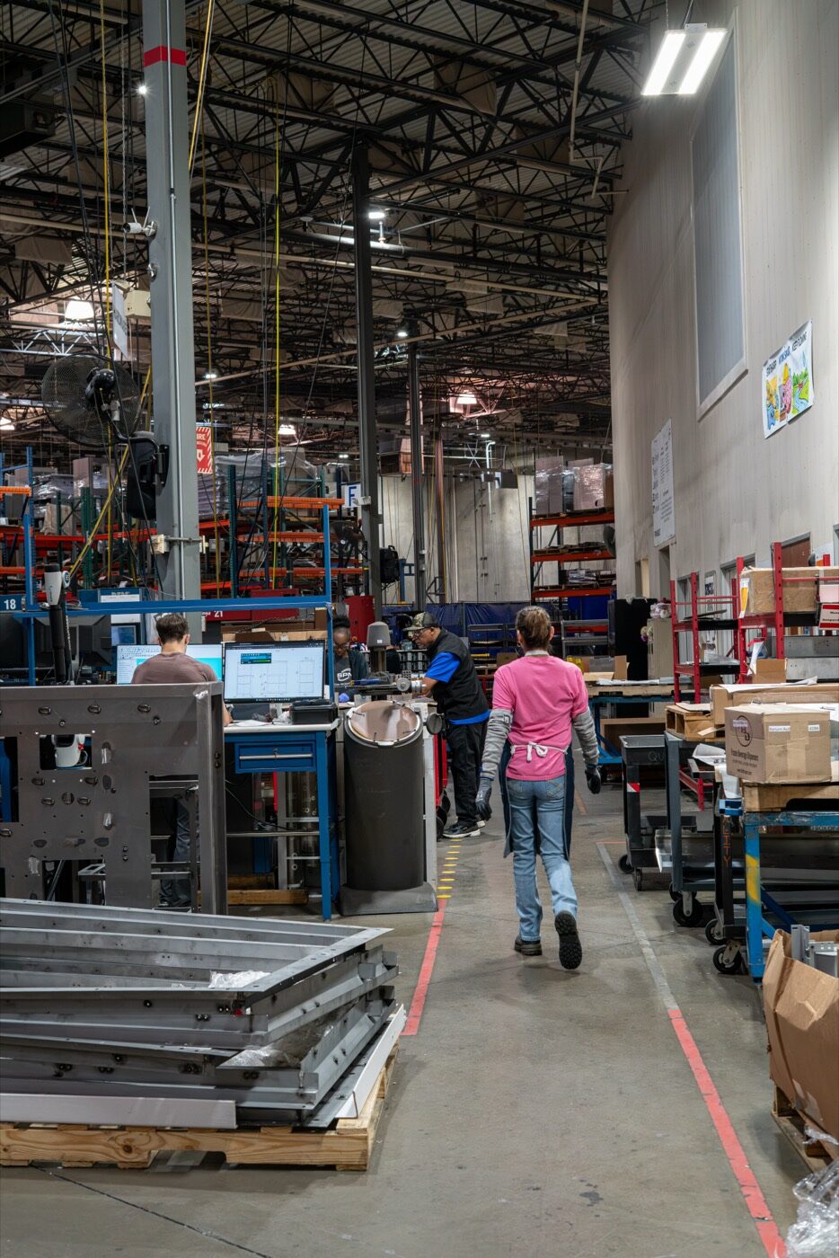 SPM team members working at stations along the Rockwall production floor