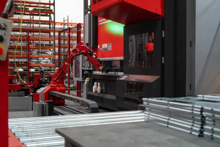 Robotic bending cell tending an Amada press brake on SPM’s Rockwall fabrication floor